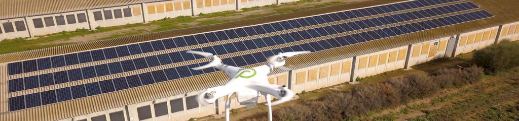 vista de la teulada de la granja avícola amb 150 mòduls fotovoltaics i del dron de Jorfe sobrevolant la instal·lació fotovoltaica 